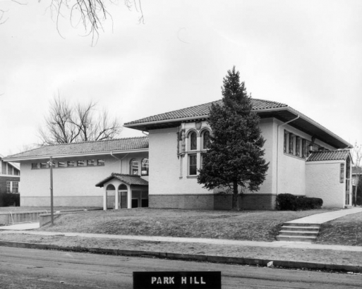 View of the Park Hill Branch of the Denver Public Library (architects M.R. & Burnham Hoyt) at Dexter Street and Montview Boulevard in Denver, Colorado; features a tile roof, stucco finish, leaded glass, and a bay window with entablature.