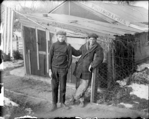Outdoor portrait of teenaged boys with cigars by the Charles S. Lillybridge home in Denver, Colorado; sign reads: "Scenic Photographer."