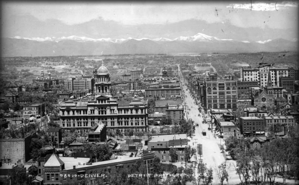 Rooftop view of 16th (Sixteenth) Street in downtown Denver, Colorado. Street cars and horse-drawn wagons are on the street. Buildings include the Arapahoe County Courthouse, Kittredge Building, and Equitable Building.