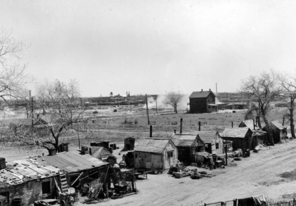 View of makeshift houses and shanties at 19th (Nineteenth) and Clay Streets in the Jefferson Park neighborhood of Denver, Colorado.