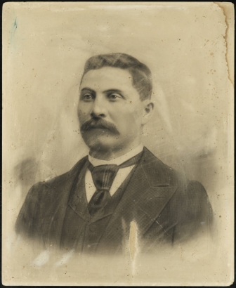 Portrait of William Denver McGaa, the first child born in Denver, Colorado. He wears a suit, vest, tie, and stiff collared shirt. He was named after Governor James Denver of Kansas Territory.