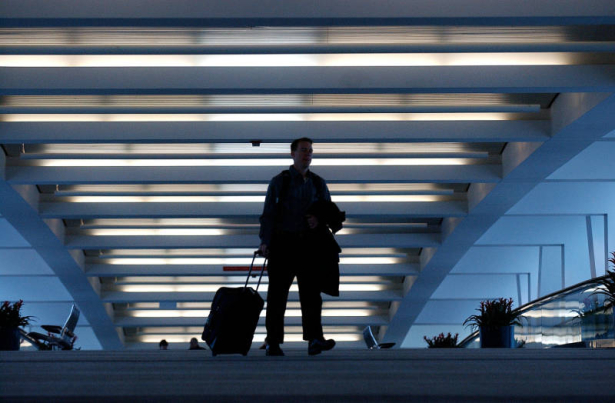 (DENVER Colo., February 15, 2005) Remster (cq) Bingham , of Boulder, walks across the sky bridge at DIA February 15, 2005. The bridge connects the Jeppesen Terminal with Concourse A. The airport is turning 10 years old February 28, 2005. (Photo by KEN ...
