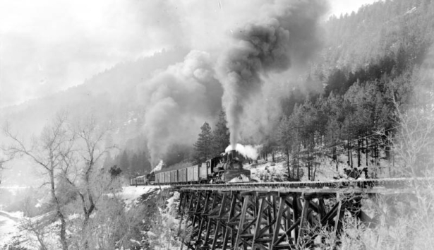 Three-quarter view of left side of engine, from front end; on trestle, with helper engine 452; smoke; snow. Photographed: Wade, Colorado,  November 19, 1951.