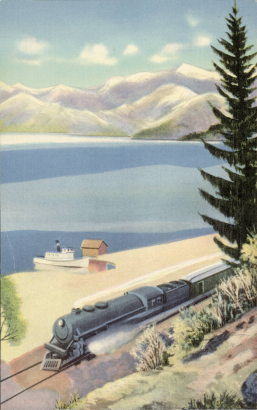 View of Lake Pend Oreille in Idaho shows a Northern Pacific train near the shore with a boat and boathouse nearby. Mountains are in the distance.