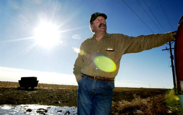 (YUMA., Colo., Dec. 12, 2005) Kenny Rogers leans against his truck, near a piece of property where the family rents out farm land. The Rogers family in Yuma, Colorado has maintained the Wagon Wheel Ranch since 1950. They have participated in the Nation...