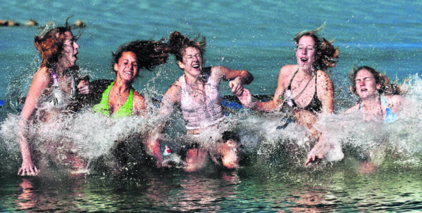 Members of the Niwot 16A girls softball team  react to jumping into the cold water Sunday morning January 1, 2006, at the Boulder Reservoir.  They are from left to right Katie Ratliff, Isabelle Mastronardi, Kelsey Kreager, Abby Ratliff and Ashley Primm...