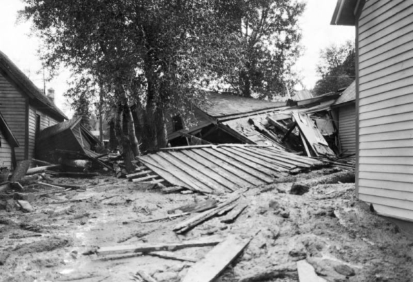 Mud and debris with damaged wood frame structures brought down by  the Cornet Creek flood on July 27, 1914, Telluride, Colorado.