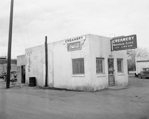 View of a business in Denver, Colorado; signs read "Creamery Meadow Gold Ice Cream," "Rainbo Bread," "Coca Cola," and "3457."