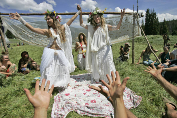 Sunny and Sun (left to right cq) are announced as wife and wife in a pagan style wedding ceremony on Tuesday morning July 4, 2006 at the 34th annual national gathering of the Rainbow Family of Living Light. The ceremony came after a morning of silence ...