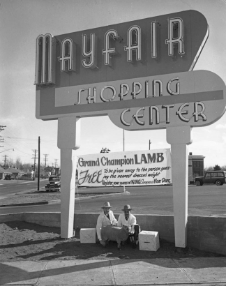 Men pose with a sheep by the Mayfair Shopping Center sign (in moderne letters) in Denver, Colorado; another sign reads: "Grand Champion Lamb, Free To Be Given To The Person Who Guesses The Nearest Dressed Weight. Register Your Guess at King Soopers Meat Dept."