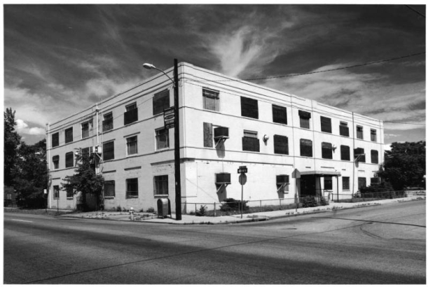 View of a three story brick commercial building at 28th (Twenty eighth) Street and Welton Street in the Five Points (or Curtis Park) Neighborhood of Denver, Colorado; features include string courses and an entry canopy.