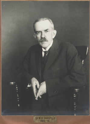 Studio portrait (seated) of Dr. William H. Sharpley, Mayor of Denver, Colorado, from 1915 to 1916.  Mayor Sharpley has a mustache and  wears a suit and tie.
