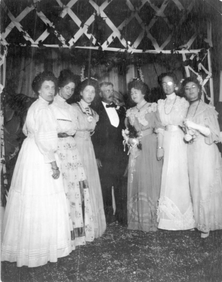 Group portrait of Denver Public Library (La Veta Place) staff at a wedding in Denver, Colorado. They are (l to r) Viva Van Allen, Irene Smith, Helen Ingersoll (DPL librarian 1898-1947), Mr. C.R. Dudley (City Librarian), Anna Hillkowitz (?), (?), and Ellen Hillkowitz. Outfits include lace and taffeta. Anna Hillkowitz is the daughter of Ella Hillkowitz and Dr. Philip Hillkowitz (one of the founders of the Jewish Consumptive Relief Society (J.C.R.S.)