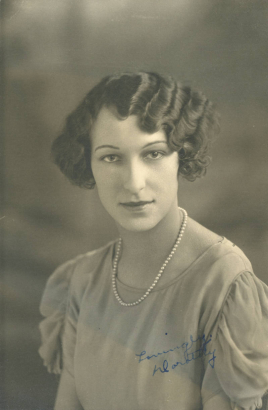 Dorothy Adler poses for her South High School senior portrait in Denver, Colorado. Adler's hair is styled in a wavy bob and she wears a blouse with sheer gathered sleeves, and a pearl necklace.