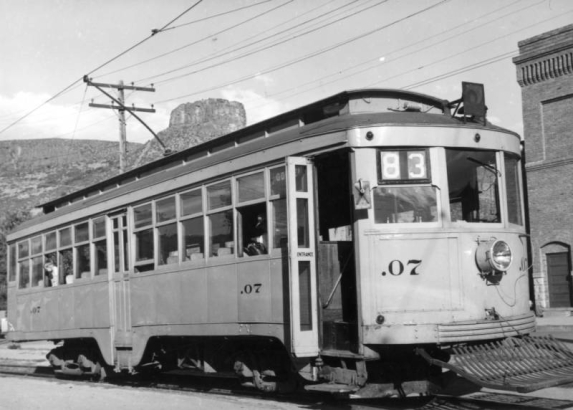 Denver City Tramway Company (Denver and Interurban Mountain Line) electric trolley car .07 at the Golden station depot of the Denver and Northwestern Railway, Jefferson County, Colorado; Castle Rock shows in background.