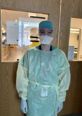 Denver Health and Hospital Authority Pavilion B staff member wearing PPE (personal protective equipment) in patient's room during Denver's COVID-19 stay-at-home order.