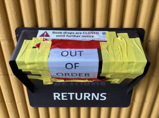 Ford-Warren Branch Library taped shut book drop during Denver's COVID-19 stay-at-home order. There is a sign on the book drop, that reads:  "OUT OF ORDER". There is also a sticker that reads:  "Book drops are CLOSED until further notice. While we are closed due dates will be extended. For updates visit, denverlibrary.org."
