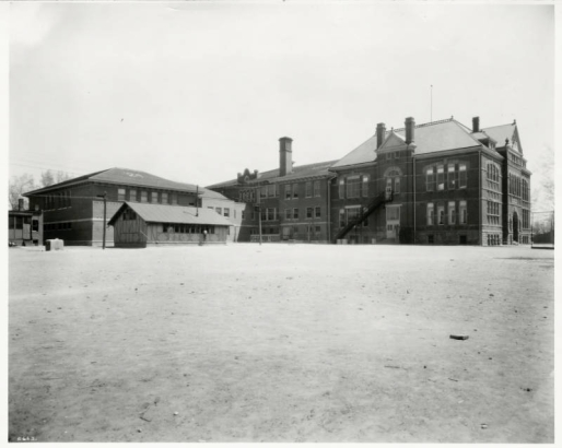 Exterior of the back of the old 24th Street School with its playground and separate buildings.  This school was  later replaced by Crofton Elementary School, in Denver, Colorado.