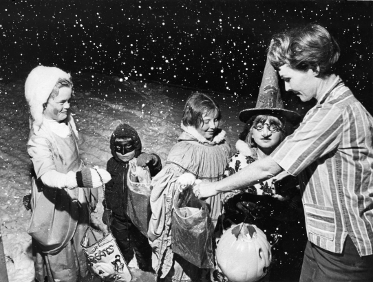 Goblins given a warm reception by Mrs. Robert Fiori. October 31, 1966. Photo by Mel Schieltz. Rocky Mountain News Photograph Collection