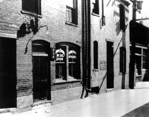 View of Ching Chung and Company Chinese store at 2019 either Wazee or Blake Street in Denver, Colorado. Chinese characters are on a nearby sign.