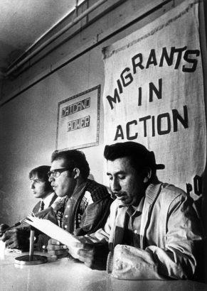 Lawyer Jonathan "Skip" Chase and Migrants in Action members Leonel Sanchez and Gregorio Salazar participate in a press conference during a protest over migrant workers' living conditions near Fort Lupton (Weld County), Colorado. Banners on the wall nearby read: "Chicano Power" and "Migrants in Action."