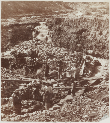View of a hydraulic mining operation at Chinese Gulch, in (probably) Colorado; shows men working, eroded ground, sluices, and wheelbarrows.