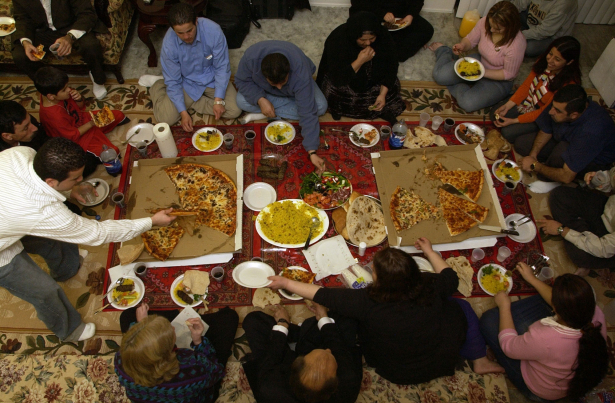 After voting in the Iraqi election, Ahmad Dizayee, bottom center, celebrates at a post-election feast at the home of Kurdish friends in San Diego. Dizayee traveled from Lakewood to Irvine, Calif., to vote Saturday. The California polling place was the only one west of the Mississippi River.