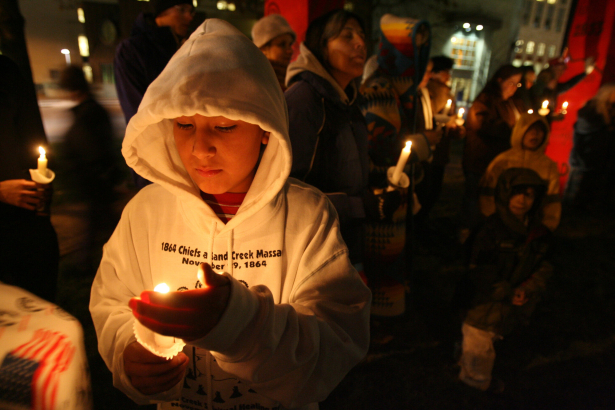 Chris Little Son, 11 of Lame Deer, MT., shields his candle