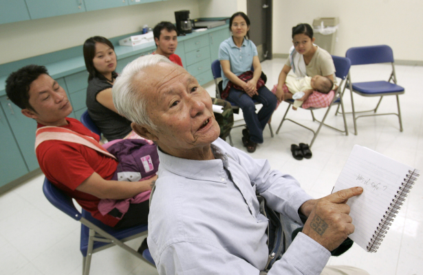 Hline Pyu, 72, a Burmese refugee, talks about the one and only time he voted in the 1950's in Burma, as a group of refugees learn about the U.S. election system at the voting center at Montclair Recreation Center in Denver.