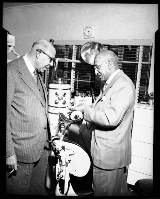 Dr. Hawkins (left) and Clarence Holmes' (right) in Holmes' dentist office