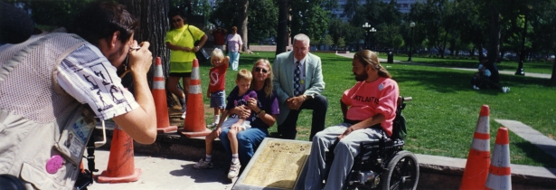 Wade Blank, his son Lincoln, and fellow Atlantis cofounder Michael Auberger celebrate the laying of the plaque, dedicated to the original protesters - The Gang of 19 - who blocked the intersection to protest the inaccessible buses in 1978. WH2283/Box5/F16