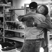 Wendell Rucker, survivor of AIDS for 7 years, hugs friend at food bank 1995