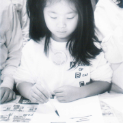 Sharon Chan at Bear Creek Elementary learns Chinese calligraphy from West High students.