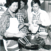 Molly Ng teaches preparation of popped rice. 1977
