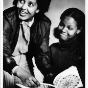 Sara Takale teaches Nigest Abreham sentences from an English Book 1984