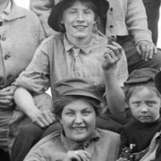 Group of young people by the river with corncob pipes and cigarettes