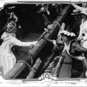 Passing the Torch August 11, 1915: A women's suffrage activist passes a torch from a boat to another woman.