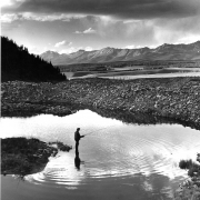 "Glory Holes for Trout mark the course of Willow Creek above the ghost town of Tincup, Colorado, in Gunnison National Forest. An angler tries for the big ones that lurk where a mining dredge went down to bedrock in search of placer gold.  