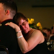 Jo Burns comforts Corporal Dustin Barker, 22, during a ceremony honoring the actions of fallen Marines.