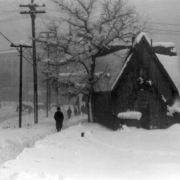 Snowy view along 17th (Seventeenth) Avenue to Broadway Avenue, Denver, Colorado, includes pedestrians on cleared walkways, horse drawn carriages in distance and a house on the estate of Mrs. H. A. W. Tabor in foreground.