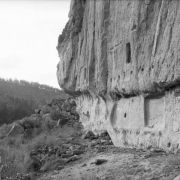 View along a soft volcanic tuff cliffside with natural caves, enlarged to create living and ceremonial spaces by ancestral Pueblo Indians, Frijoles Canyon, Bandelier National Monument, New Mexico.
