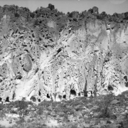Soft volcanic tuff cliffside with natural caves, enlarged to create living and ceremonial spaces by ancestral Pueblo Indians, Frijoles Canyon, Bandelier National Monument, New Mexico.
