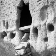 View of an enlarged entrance into a natural cave in soft volcanic  rock, Frijoles Canyon, Bandelier National Monument, New Mexico; occupied by ancestral Pueblo Indians between the 13th (thirteenth) and 16th (sixteenth) century.