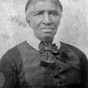 "Aunt" Clara Brown, at about age 70, poses in a dark dress and crocheted cap. Born a slave, This businesswoman was the first Black inductee into the Society of Colorado Pioneers.