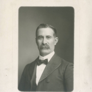 Studio portrait of Colorado State Senator Casimiro Barela from Rivera (Las Animas County), Colorado, made on the occasion of his 64th birthday. Senator Barela wears a jacket with piping, a bow tie and upright collar, He has a full, waxed mustache.