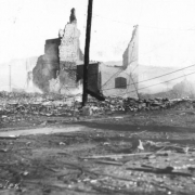 Brick rubble and partial walls of Palace Hotel, Bennett Avenue and Second (2nd) Street, destroyed by second fire of April 29, 1896, Cripple Creek, Colorado; smouldering debris.