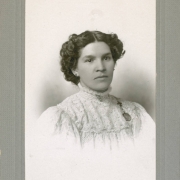 Studio portrait of Sofía Barela Lucero, the adopted daughter of Colorado State Senator Casimiro Barela. She wears a lace blouse and a religious medal.