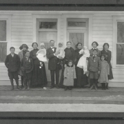 Group portrait of Colorado State Senator Casimiro Barela, his wife Damiana Rivera de Barela, their daughters and grandchildren on the porch of their house (Rancho de Rivera) in Rivera (Las Animas County), Colorado. Senator Barela holds an unidentified grandchild and his wife stand beside him with her hands on the shoulders of a young girl.