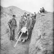 Workmen pose in a trench near a wooden pipe form in Denver, Colorado.