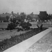 View of the estate of Casimiro Barela in Rivera, Las Animas County, Colorado; shows house, sidewalks, and picket fence.